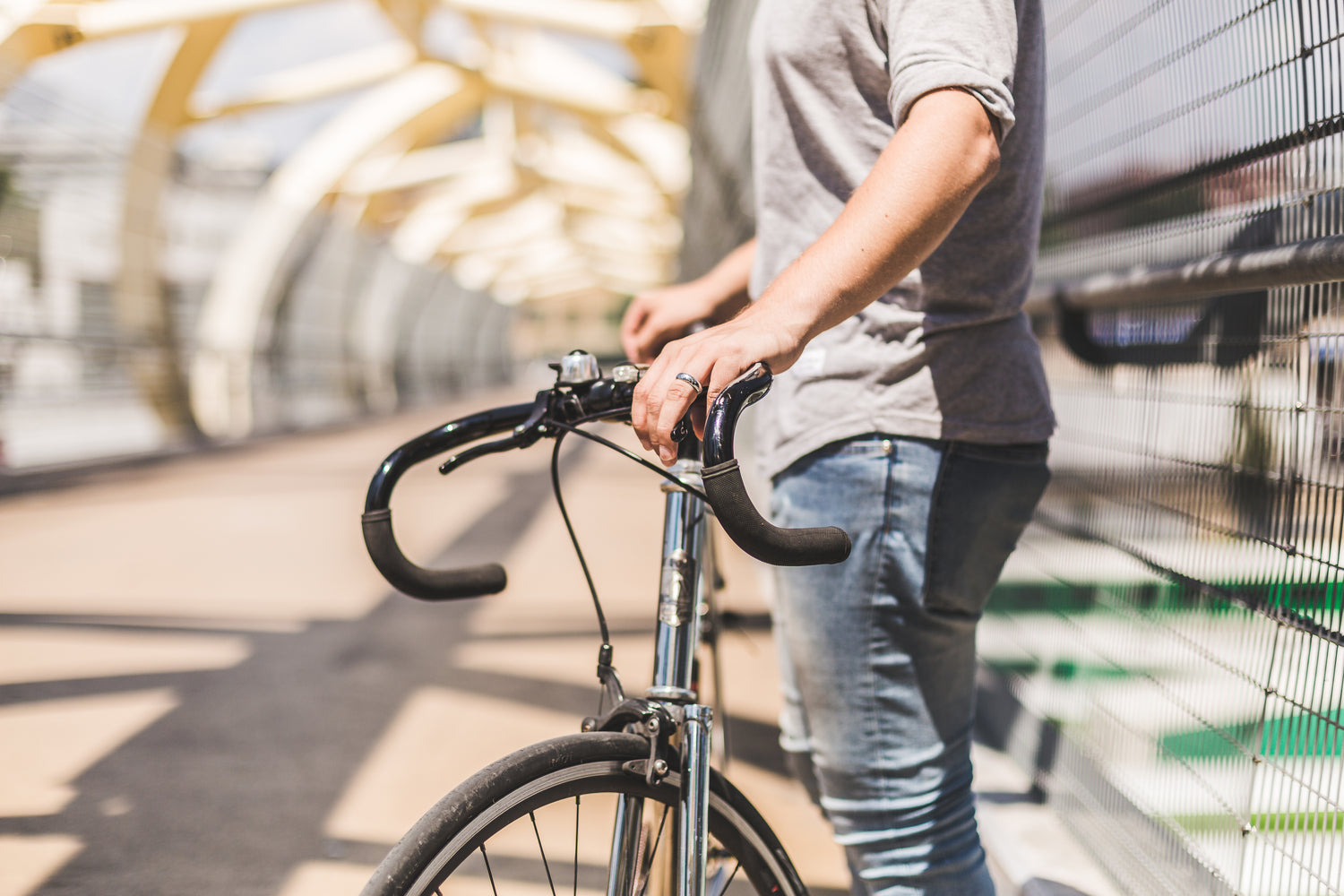 Picture of a man holding onto the bars of a retro bicycle. 